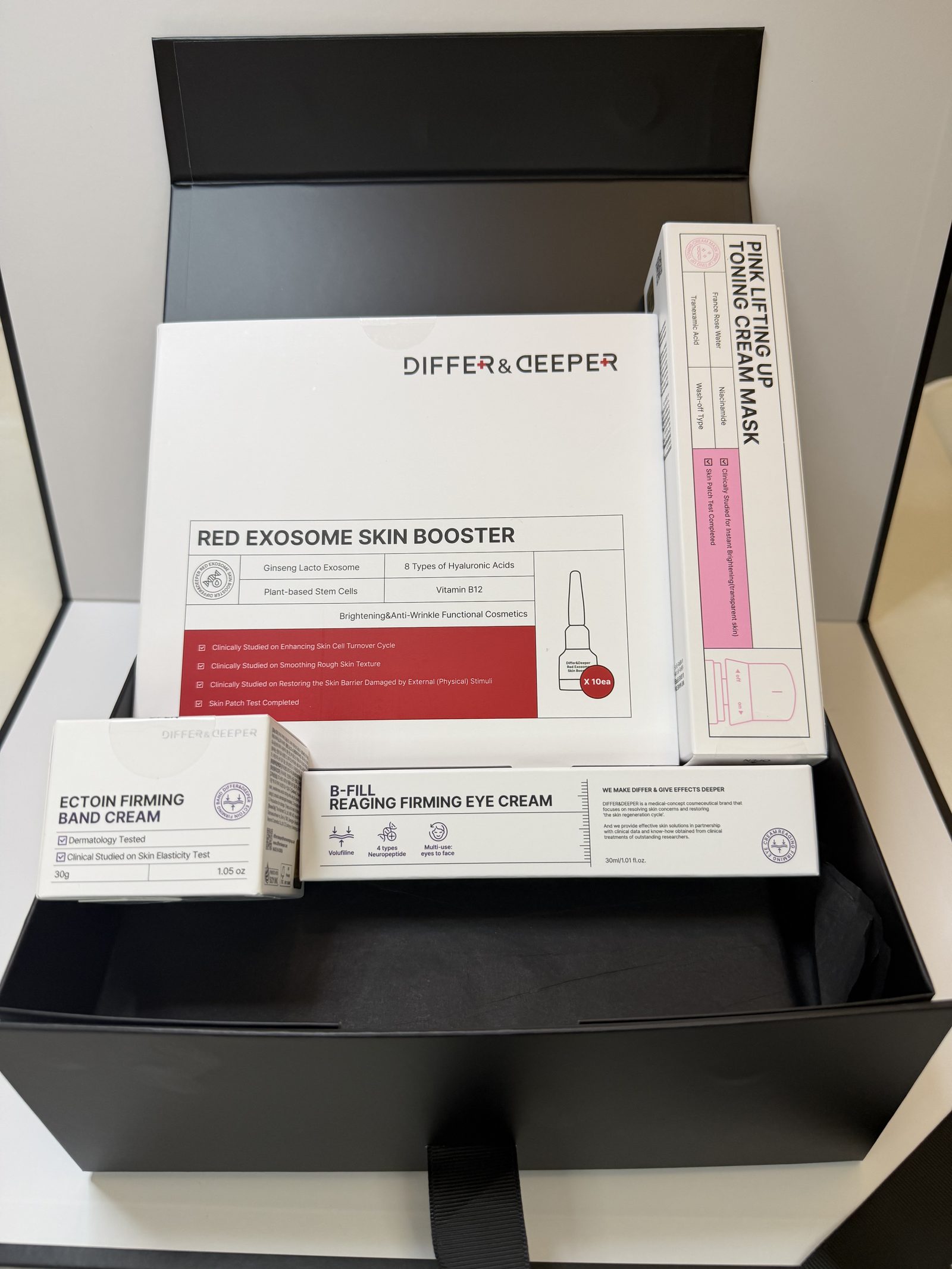 Red Renewal Bundle gift box open with products propped up